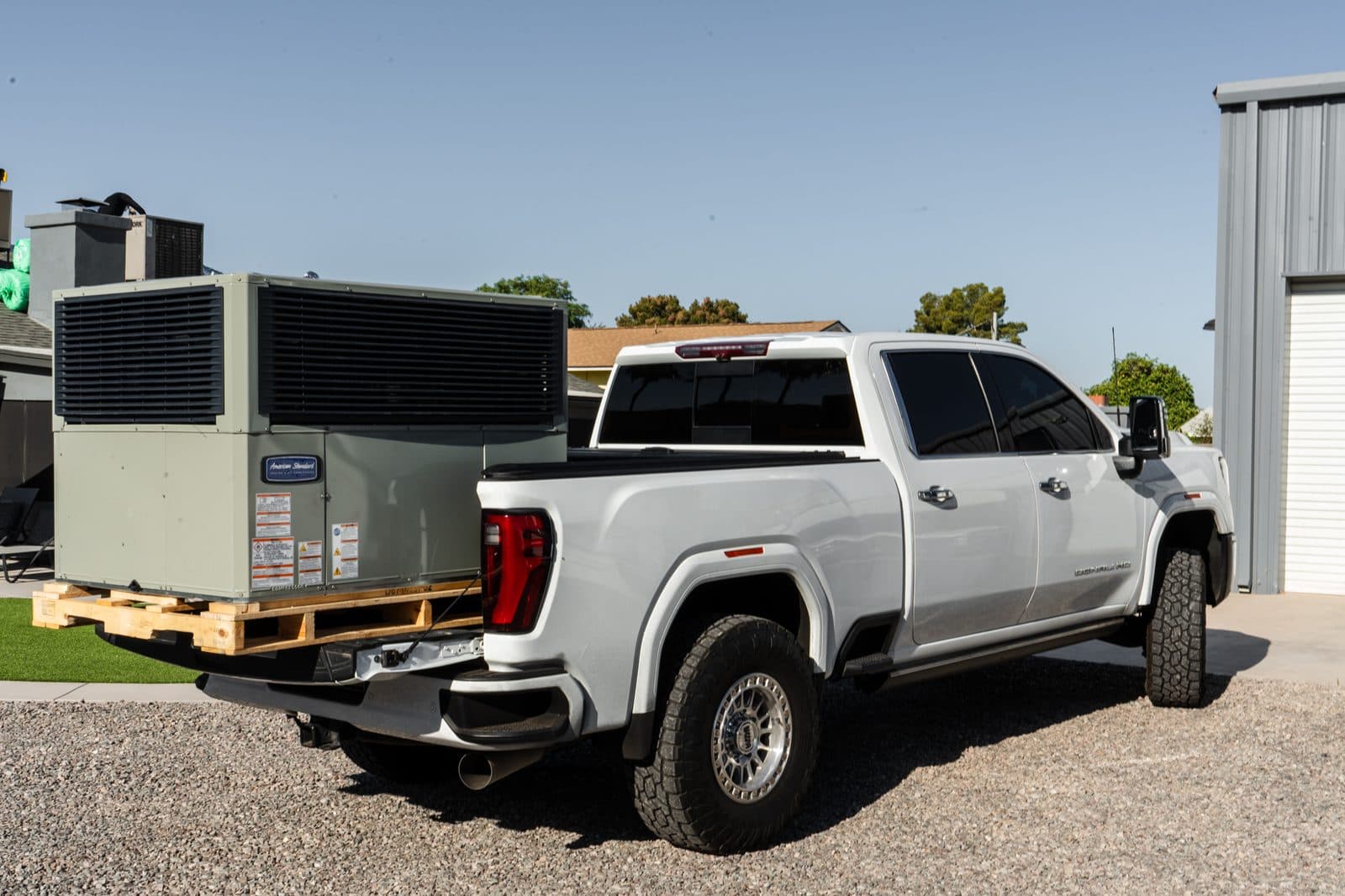 Packaged units on a pallet strapped to a truck bed