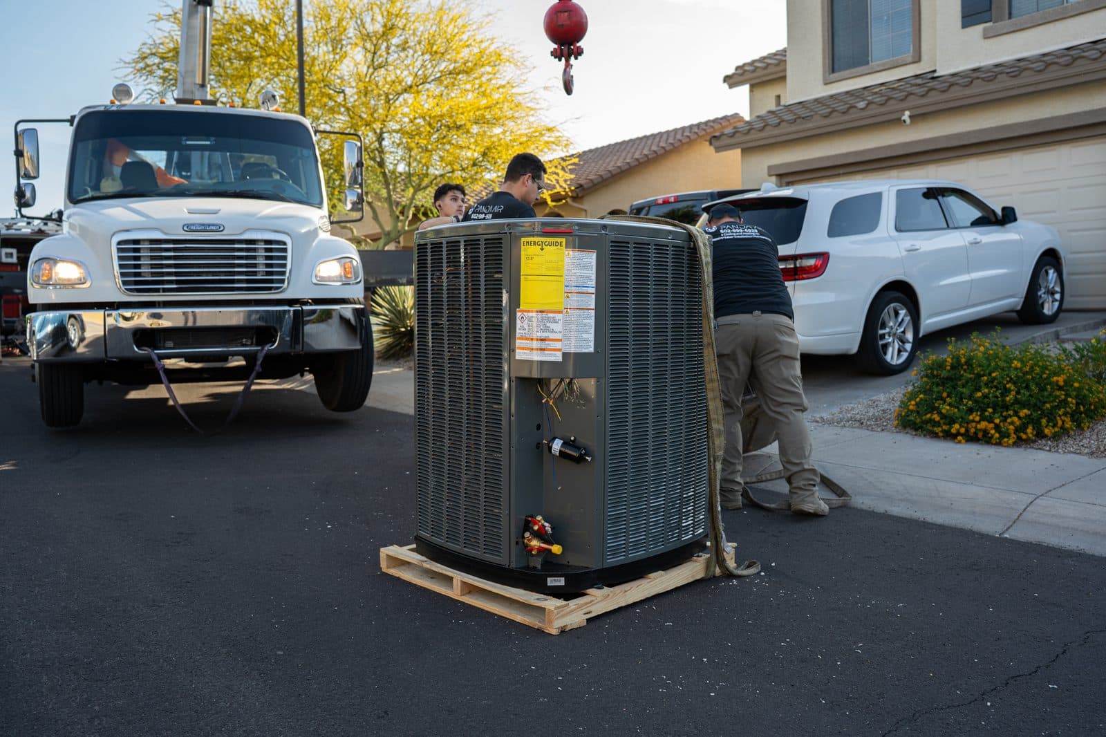New condensing unit on a pallet in front of a crane truck